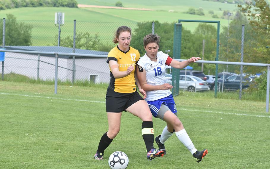 Stuttgart's Anna Thompson and Wiesbaden's McKinley Viers battle for the ball Wednesday, May 17, 2023, in the semifinals of the DODEA-Europe Division I girls championships.