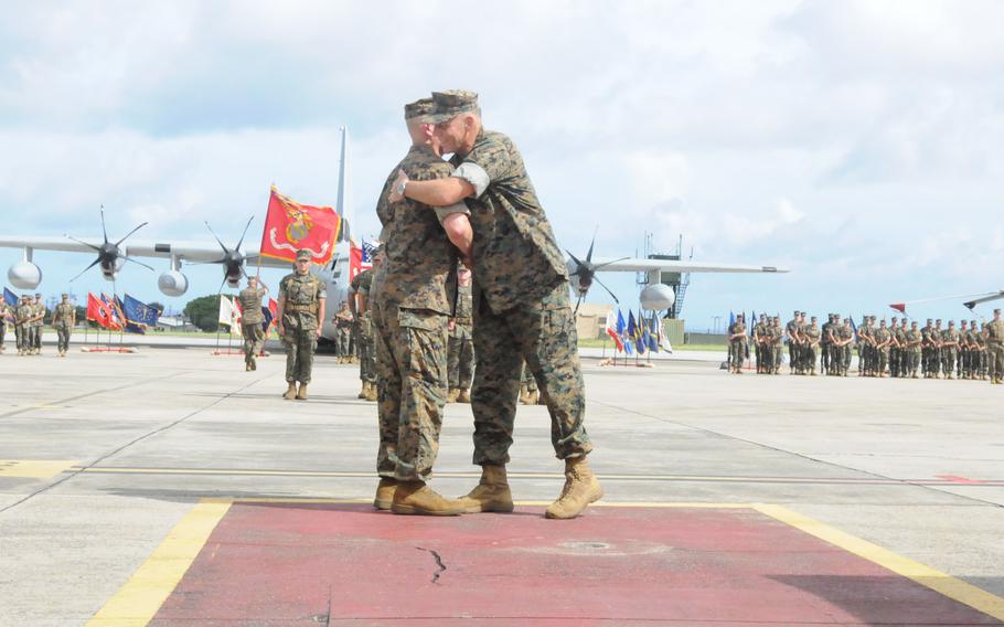 Maj. Gen. Eric Austin, right, outgoing commander of the 1st Marine Aircraft Wing, embraces incoming commander Maj. Gen. Marcus Annibale on July 12, 2024, at Marine Corps Air Station Futenma, Okinawa, Japan.
