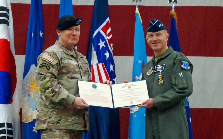 Army Gen. Paul LaCamera, commander of U.S. Forces Korea, presents Lt. Gen. Scott Pleus, outgoing 7th Air Force commander, with the Defense Distinguished Service Medal at Osan Air Base, South Korea, Jan. 30, 2024. 