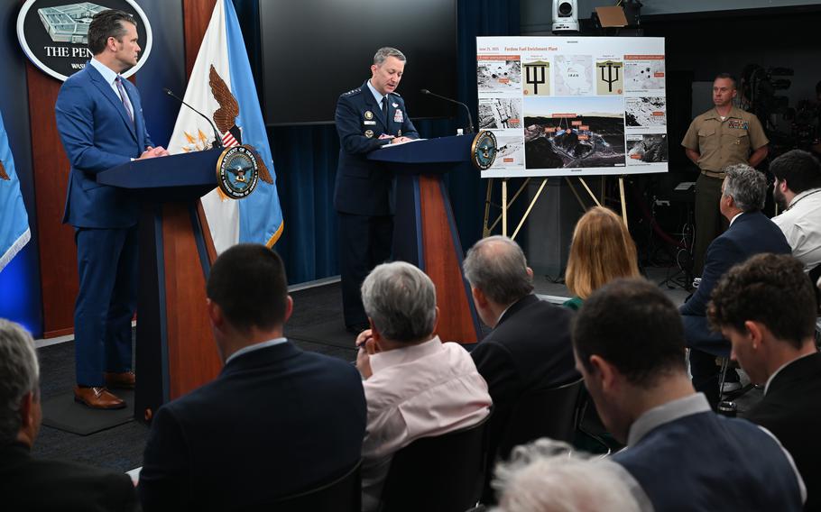 Gen. Dan Caine, on the right at a podium, speaks while Defense Secretary Pete Hegseth looks on from another podium on the left.