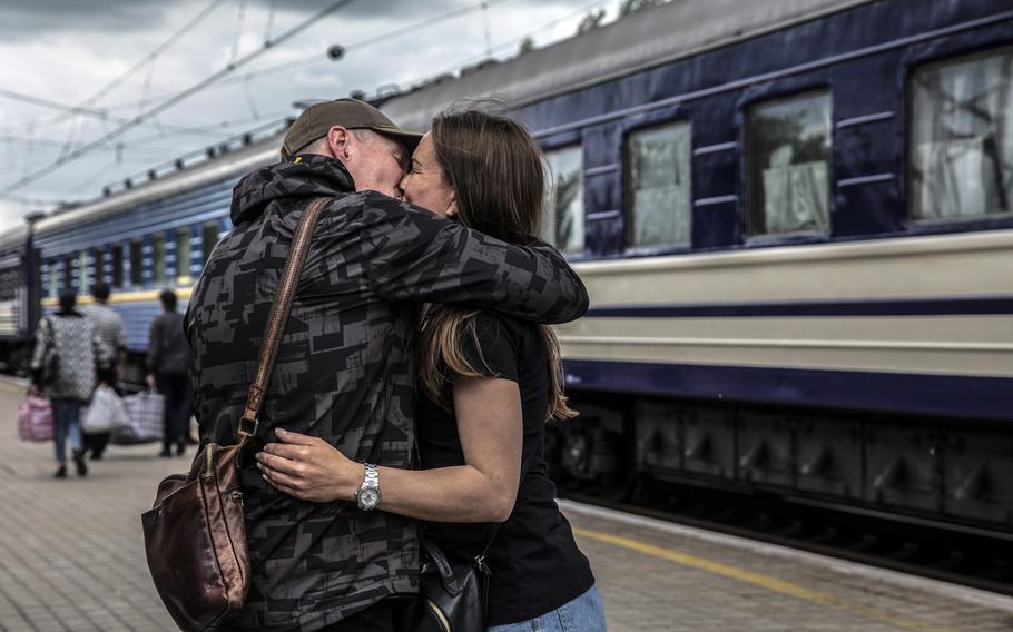 A young couple say their goodbyes before the woman boarded an evacuation train at the railway station in Pokrovsk on May 28, 2022. 