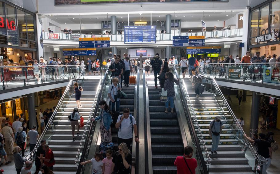Travelers make their way through the main train station in Nuremberg, Germany, on May 29, 2023.