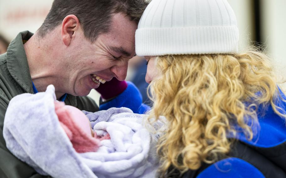 Lt. Andrew Cannata becomes emotional as he holds his 2-month-old baby girl for the first time with his wife Carissa at Naval Air Station Oceana on Monday, Jan. 15, 2023, after coming home from an eight-month deployment with the USS Gerald R. Ford.