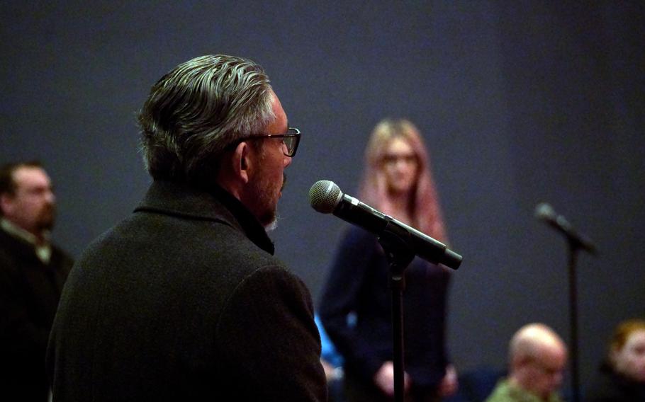 A man asks a question about civilians' access to health care during a town hall meeting at Yokosuka Naval Base, Japan, Tuesday, Jan. 31, 2023.