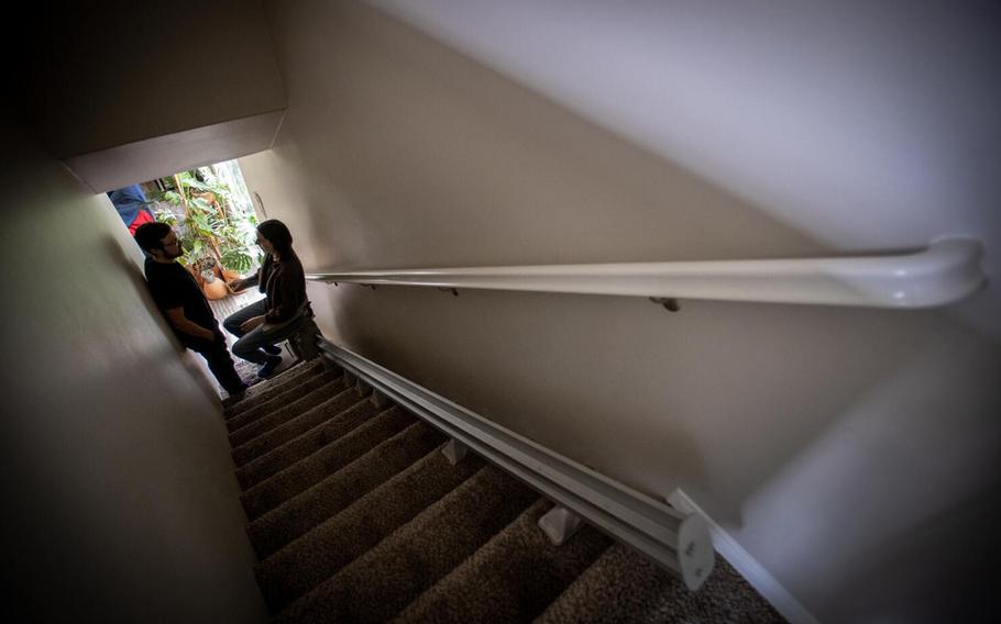 Courtney Gavin, takes a break from coming down the chairlift from her upstairs room, as her husband Connor Mayer prepares to help her doing basic tasks in the home on Feb. 14, 2023. Courtney got sick with Covid in March 2020 and is now sick with long covid. 