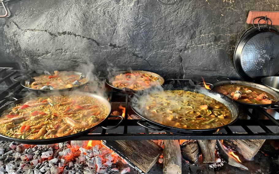 Paellas simmer over the wood fire in the open-air kitchen at Sa Foradada. The tiny, rustic eatery clings to a wind-swept, rocky promontory jutting into the western Mediterranean. 