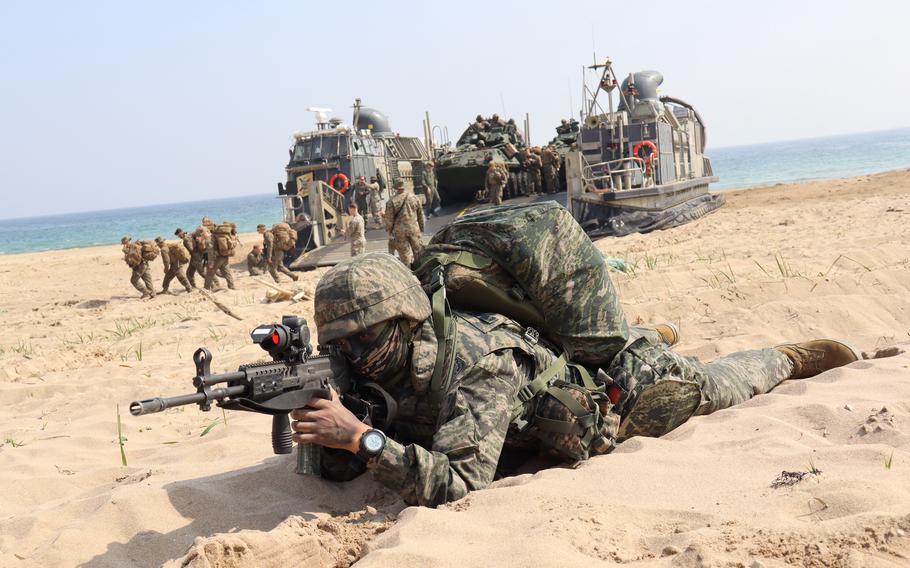 A South Korean marine takes his position as U.S. Marines from the 13th Marine Expeditionary Unit disembark from a landing craft during the Ssangyong Exercise in Pohang, South Korea, March 29, 2023. 