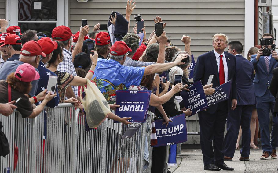 Former president Donald Trump attends the opening for his New Hampshire campaign headquarters on Tuesday.