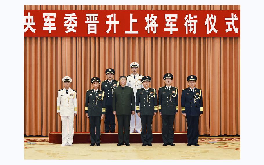 Chinese President Xi Jinping who is also chairman of the Central Military Commission poses with other military leaders during a ceremony to promote two military officers to the rank of general in Beijing on Dec. 25, 2023. 