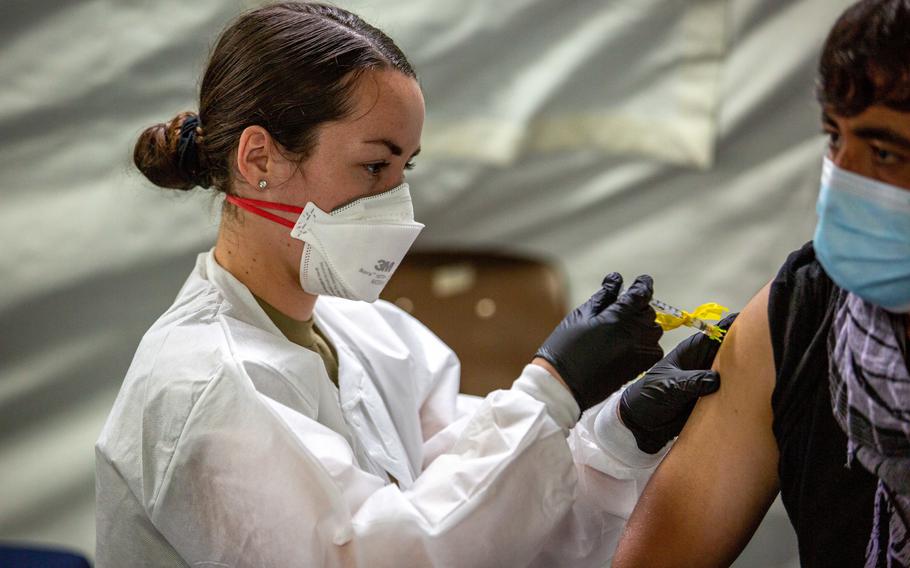 U.S. Air Force Senior Airman Julia Evans, a medic with the 96th Medical Group, provides a Pfizer COVID vaccination to an Afghan individual on Fort Pickett, Va., Sept. 18, 2021. A team of military medical personnel from the 96th Medical Group arrived at Central Maine Medical Center over the weekend, where they’ll be assisting providers for at least the next month under a federal COVID-19 response program.