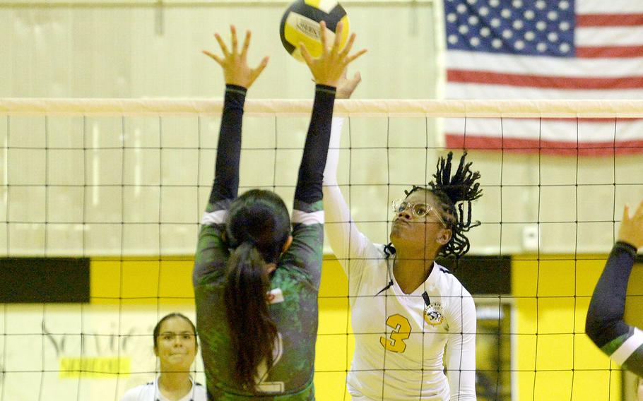 Kadena's Liza Young spikes against Kubasaki's Runa Holladay during Tuesday's Okinawa volleyball match. The Dragons won in four sets and won the season series 3-1.