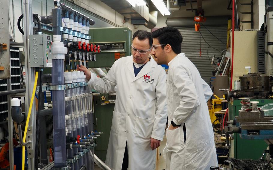 Madjid Mohseni, left, a professor of chemical and biological engineering, and postdoctoral fellow Ehsan Banayan Esfahani look at a pilot water-treatment system in March.