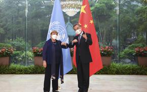 In this photo released by Xinhua News Agency, Chinese Foreign Minister Wang Yi, right, meets with the United Nations High Commissioner for Human Rights Michelle Bachelet in Guangzhou, southern China's Guangdong Province on Monday, May 23, 2022. (Deng Hua/Xinhua via AP)