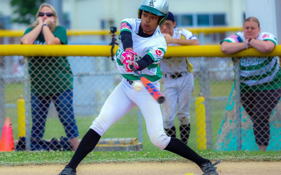 Kubasaki's Luka Koja connects against Kadena during the Dragons' 13-5 semifinal win Tuesday in the Division I baseball tournament.