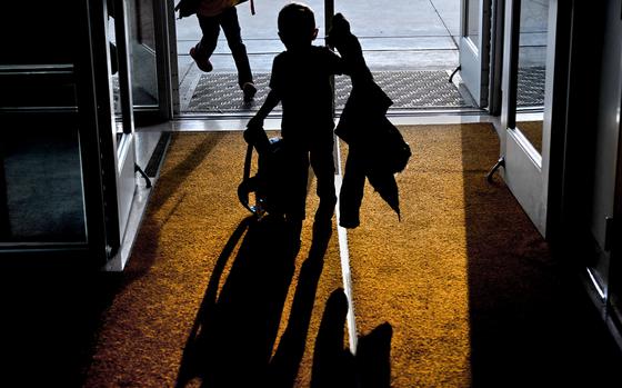 Students rush through the front door of their school after leaving the bus in Nelsonville, Ohio, on March 21, 2023. MUST CREDIT: Michael S. Williamson/The Washington Post