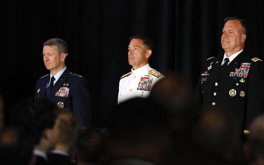 The Joint Chiefs chairman, outgoing general and incoming admiral stand at attention during a change of command. 