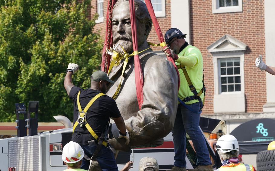 Crews remove the torso of Confederate General Robert E. Lee, one of the country's largest remaining monuments to the Confederacy, on Monument Avenue in Richmond, Va., Wednesday, Sept. 8, 2021.