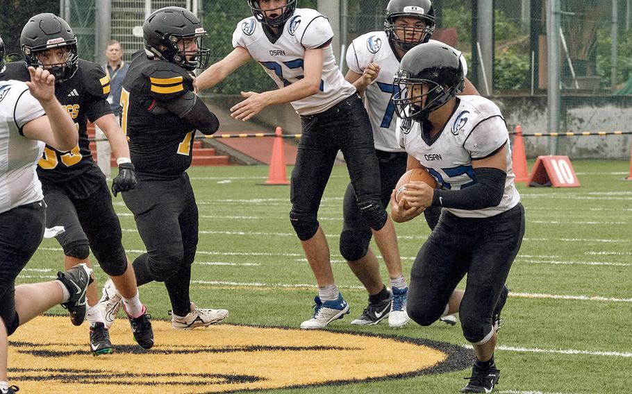 Osan's Eddie Kim looks for running room against American School In Japan.