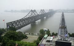 Visitors walk across the Yalu River Broken Bridge, right, next to the Friendship Bridge connecting China and North Korea in Dandong in northeastern China's Liaoning province, Sept. 9, 2017. After spending two years in a strict lockdown because of the COVID-19 pandemic, North Korea may finally be opening up — slowly. The reason could reflect a growing sense of recognition by the leadership that the nation badly needs to win outside economic relief.