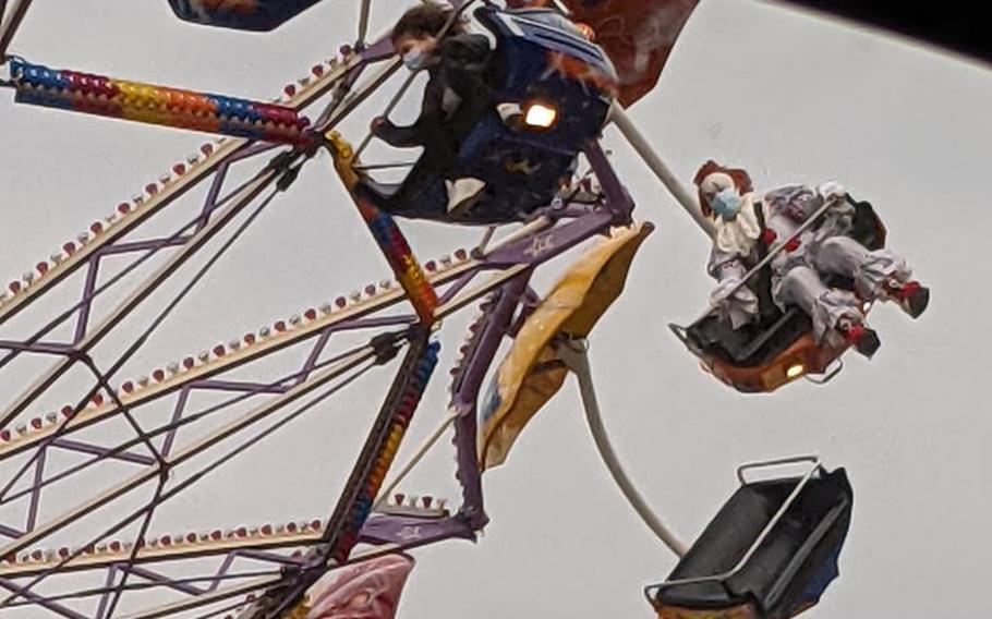 Someone dressed as Pennywise the Dancing Clown from the 2017 and 2019 adaptations of the Stephen King novel ''It'' enjoys a carnival ride Oct. 17, 2021, at the Barbarossaland fair in Kaiserslautern, Germany. The sight of the clown spooked Air Force Staff Sgt. Alexis Smith, whose husband was later creeped out when he ran into the laughing harlequin outside a mirror maze attraction.