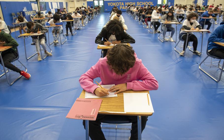 Students at Yokota High School in Japan take the Armed Services Vocational Aptitude Battery in 2021. The Pentagon is planning a change on the military's entrance exam that will allow applicants to use calculators.