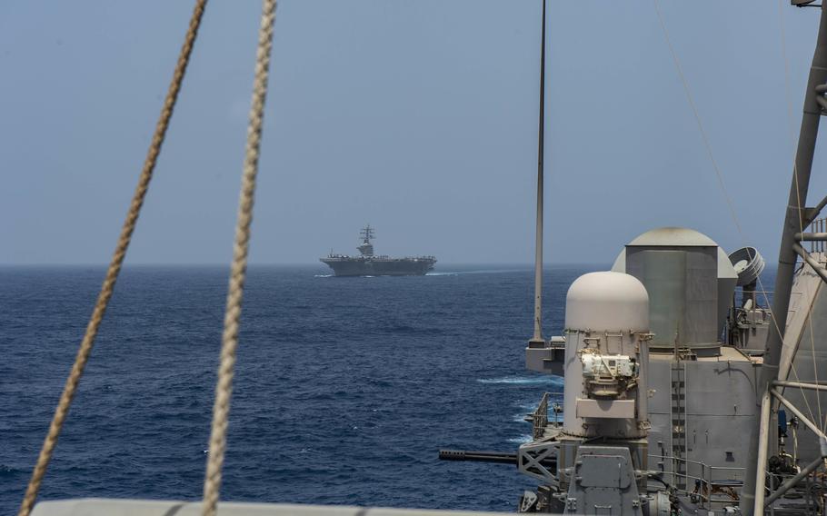 Aircraft carrier USS Dwight D. Eisenhower (CVN 69) sails in formation with guided-missile cruiser USS Vella Gulf (CG 72), in the Arabian Sea, June 22, 2021. 
