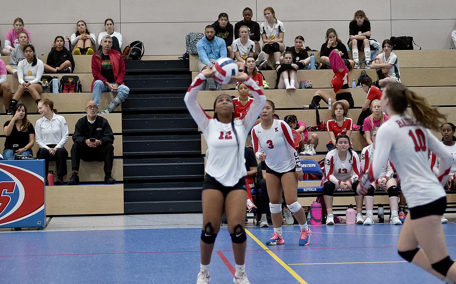 Kaiserslautern's Se'maiya Farrow, center, sets the ball while teammate Mariska Campbell, right, gets into position and Isabella Daep, background, watches during a DODEA European volleyball championship pool-play match against Wiesbaden on Friday at Ramstein High School on Ramstein Air Base, Germany.
