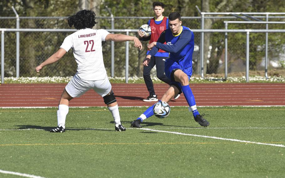 Wiesbaden's Ante Dugandzic crosses the ball past Lakenheath junior Rylen Pontemayor during a game in Wiesbaden on April 6, 2024.