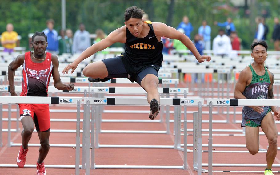 Vicenza’s Zachary Denton clears the last hurdle on his way to winning the 110-meter event at the DODEA-Europe track and field championships in Kaiserslautern, Germany, May 20, 2023, in 14.93 seconds. At left is Kaiserslautern’s Jerrell Thomas who took second and AFNORTH’s Connor Luminarias who placed fourth, at right.