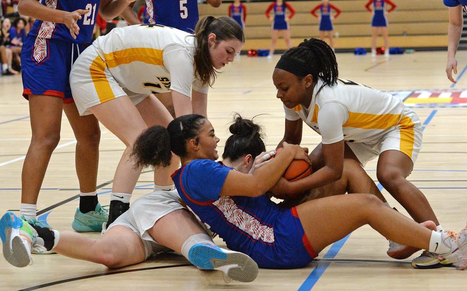 Ramstein’s Parker Ingram battles Stuttgart’s Macayla Hines for the ball in the girls Division I final at the DODEA-Europe basketball championships in Wiesbaden, Germany, Feb. 17, 2024. Stuttgart beat Ramstein 33-26 to take the title.