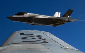 An F-35A Lightning II assigned to the 355th Fighter Squadron flies in formation after receiving fuel from a KC-135 Stratotanker near Eielson Air Force Base, Alaska, Aug. 22, 2025.