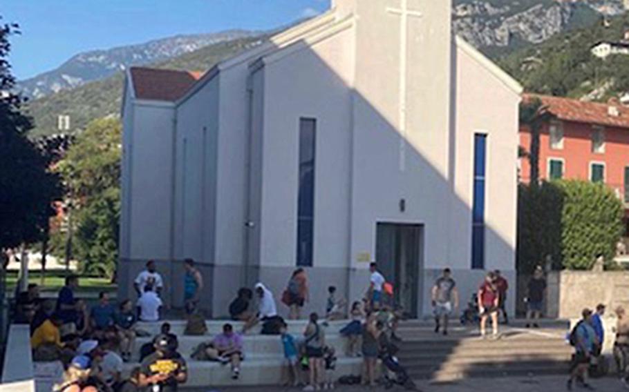 Paratroopers from the 173rd Airborne Brigade take a load off in the town square of Torbole, Italy, on Sept. 2, 2021, at the end of a 40-mile hike along Lake Garda. The annual hike commemorates then-Col. William Darby, the founder of the U.S. Army Rangers, and 25 infantry troops killed there in April 1945.