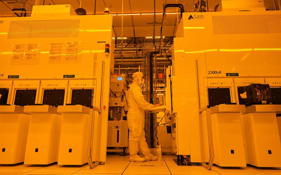 A staff member in hazesuit works in the cleanroom of a wafer fab manufacturing facility at Singapore GlobalFoundries in Singapore on Sept. 12, 2023.