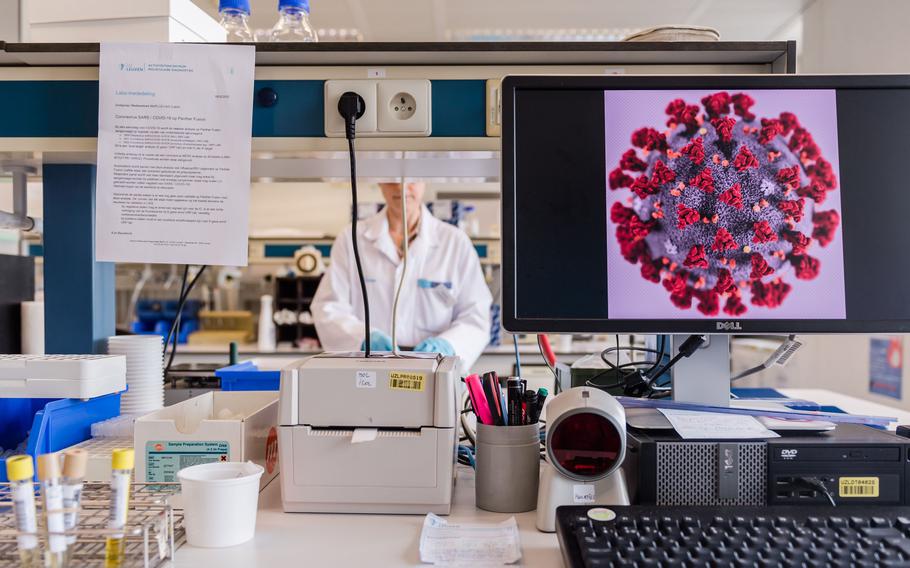 A magnified coronavirus germ is displayed on a desktop computer monitor during coronavirus patient sample detection tests in the virology research labs at UZ Leuven university hospital in Leuven, Belgium, on Friday, Feb. 28, 2020.