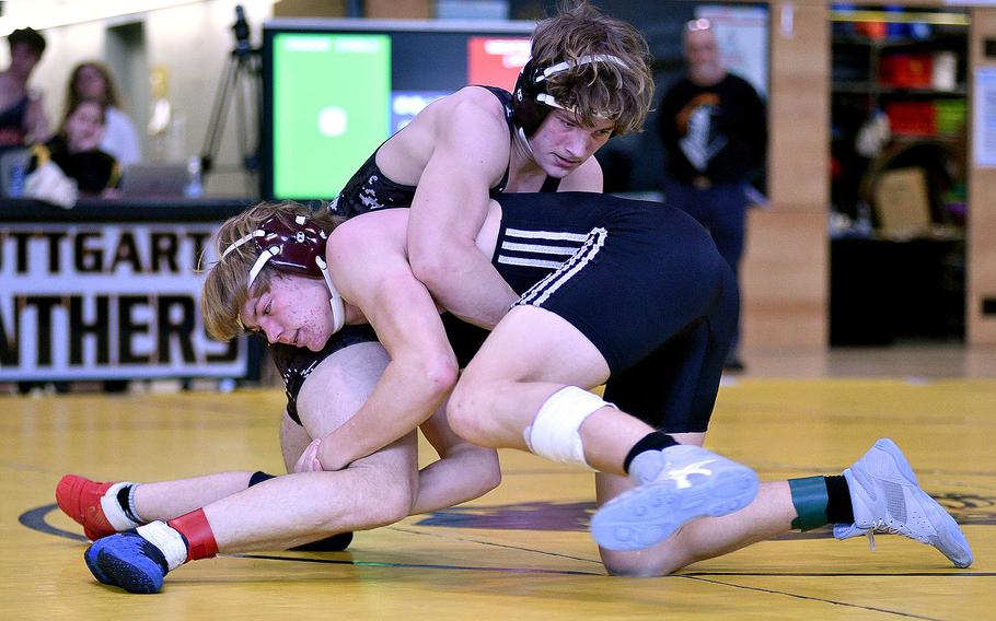 Stuttgart's Dane Westberry and Vilseck's Maverick Chase hold onto each other in a 157-poubnd semifinal during a DODEA wrestling sectional meet on Feb. 3, 2024, at Stuttgart High School in Stuttgart, Germany.