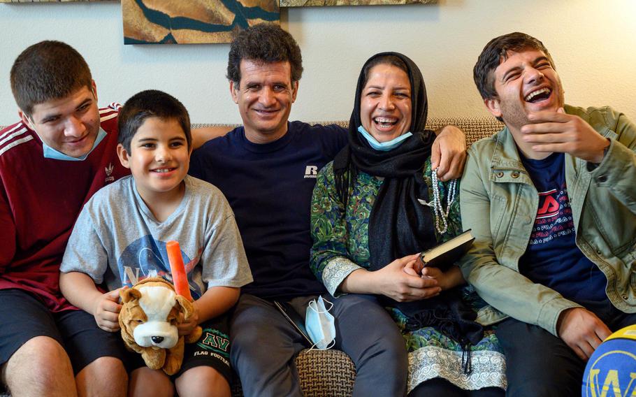 A refuge family from Afghanistan — Nasema and Firooz with their children Shahab, 17, Shikib, 8, and Shoaib, 22 — share a funny moment together at their Irvine hotel on Tuesday, Feb. 1, 2022. They arrived in the U.S. with little else than the clothes on their backs.