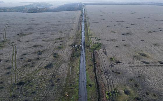 Artillery craters are seen in the field from an arial view in the recently liberated area of Kharkiv region, Ukraine, Friday, Sept. 30, 2022. (AP Photo/Evgeniy Maloletka)