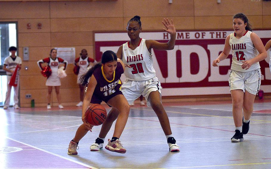 Vilseck's Giselle Villarreal dribbles along the sideline under duress from Kaiserslautern's Hazel Sanders during a Dec. 2, 2023, game at Kaiserslautern High School in Kaiserslautern, Germany