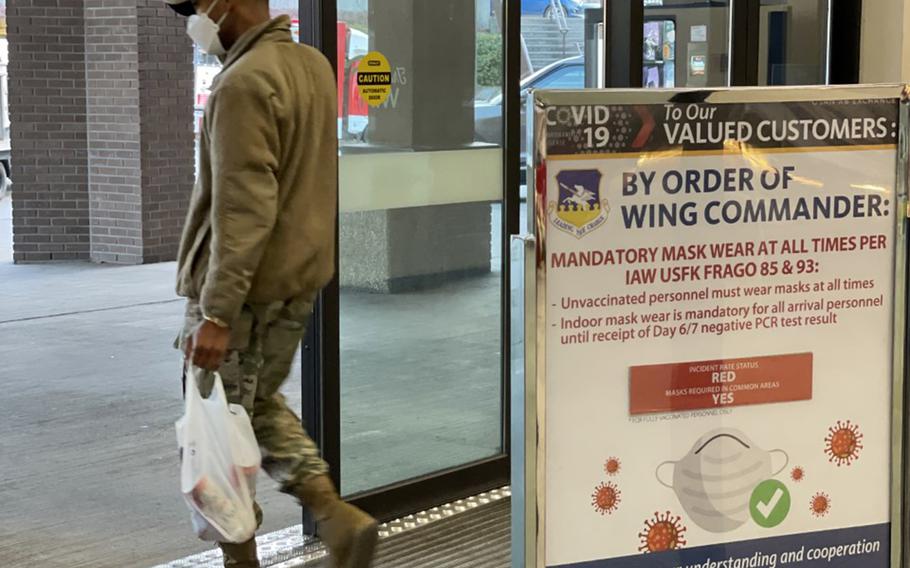 An airman wears a mask while leaving an exchange store at Osan Air Base, Japan, Jan. 7, 2022.