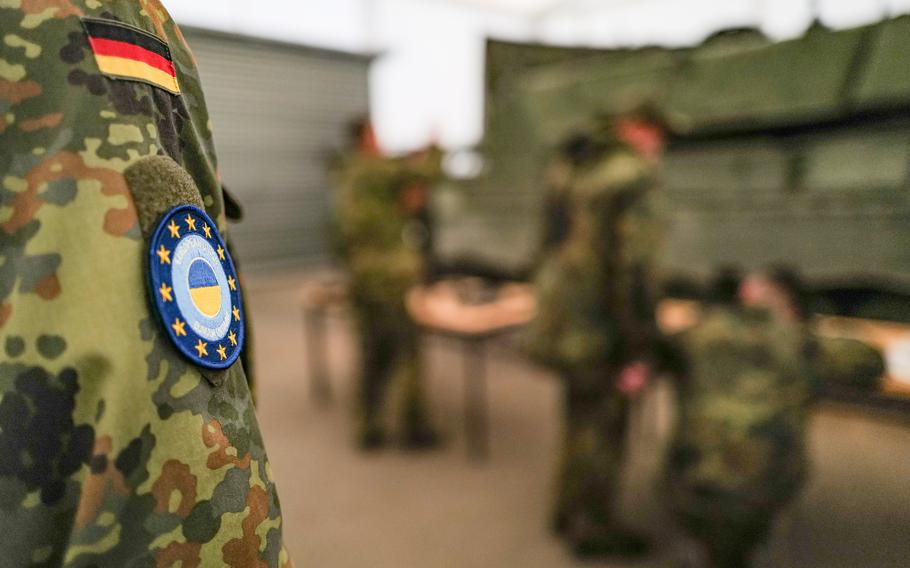 A German trainer oversees a group of Ukrainian soldiers during machine gun training at the Klietz range in Germany on June 13, 2024.