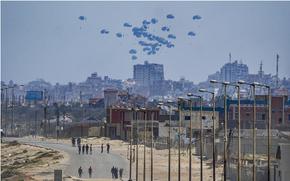 An aircraft airdrops humanitarian aid over the northern Gaza Strip, as seen from central Gaza, Tuesday, April 30, 2024.