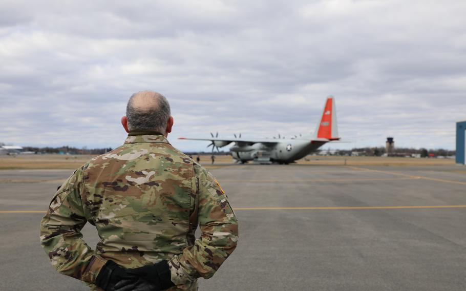 Col. Richard Goldenberg stands at parade rest as a New York Air National Guard LC-130 carrying the remains of New York Army National Guard Chief Warrant Officers 2 Casey Frankoski and John Grassia III moves into position at the Army Aviation Support Facility in Latham, N.Y., on Monday, March 18, 2024. 