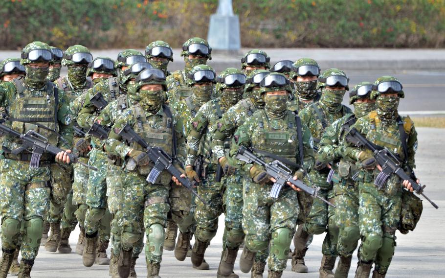 Members of Taiwan’s 564th Armored Brigade run in formation near Kaohsiung, Taiwan, Jan. 11, 2023.