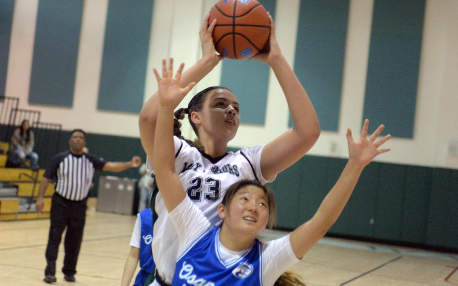 Daegu's Jasmine Harvey puts up a shot over Osan's Ashley Kim during Friday's Korea girls basketball game. The Warriors won 28-17.