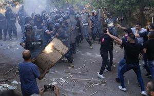 Lebanese Armenians clash with police outside the Azerbaijani embassy in Beirut, Lebanon, Thursday, Sept. 28, 2023. The scuffles came during their protest on Thursday to denounce the Azerbaijani military offensive that recaptured Nagorno-Karabakh from the separatist Armenian authorities in the enclave. (AP Photo/Hussein Malla)