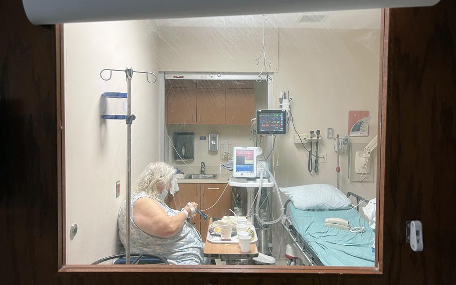 Mary Balcerzak, who is coronavirus-positive, sits in an isolation room inside the Kent Hospital emergency department. 
