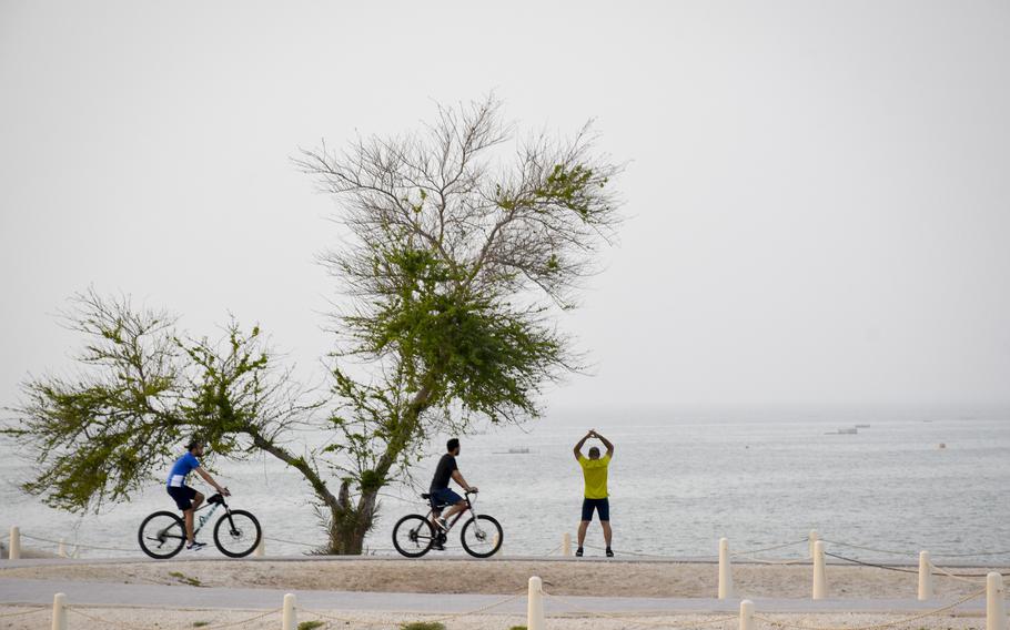 Bikers and joggers race around the wide paved paths at Qal’at al-Bahrain in Manama, Bahrain, on April 16, 2022.