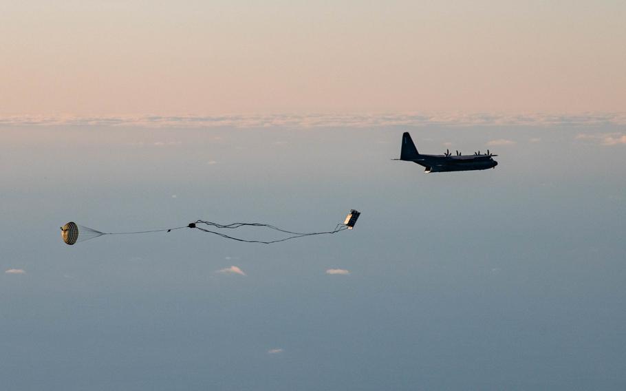 A palletized munitions system falls from the cargo hold of a 352d Special Operations Wing MC-130J Commando II during a live-fire demonstration in Norway, Nov. 9, 2022. 