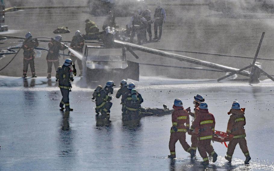 Marine Corps and Japanese first responders train to a handle a military helicopter crash at Camp Hansen, Okinawa, Thursday, Feb. 9, 2023.