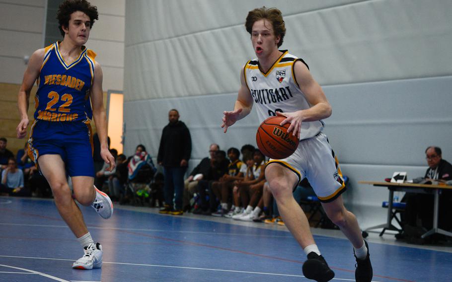 Stuttgart’s Jacob Schudel outruns Wiesbaden defender Teagan McConville during the DODEA European Division I boys basketball championships Feb. 16, 2023, at Ramstein Air Base, Germany.